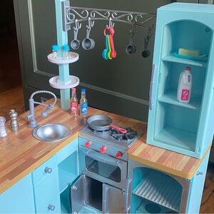 2 American Girl Dolls + American Girl Doll Kitchen and Chair. Value $550.